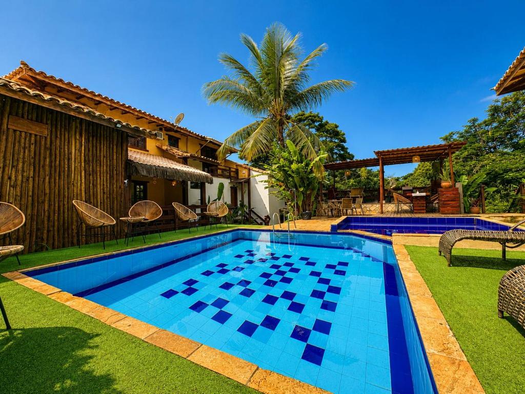 a swimming pool in the yard of a house at EstrelaMar Boutique in Búzios