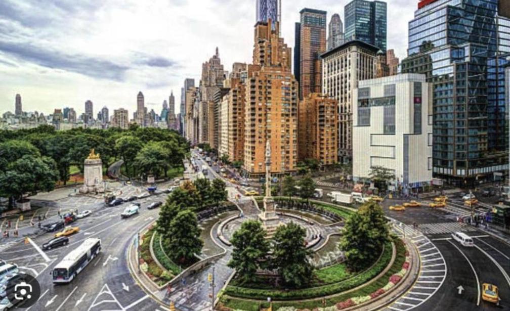 a city with a busy street with cars and buildings at Lavish Columbus Circle Manhattan Apartment by Central Park & Times Square ADULTS ONLY in New York