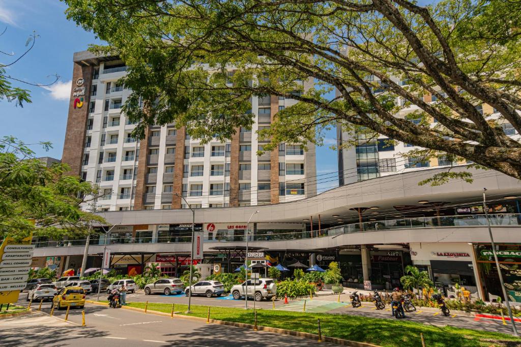 a large building with a parking lot in front of it at Cerritos Premium Tower & Mall in Pereira