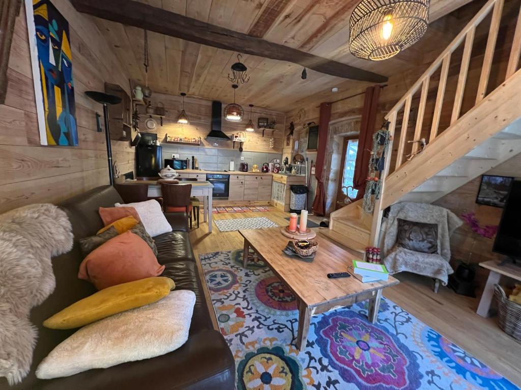 a living room with a couch and a table at le Chalet in Saint-Loup-sur-Thouet