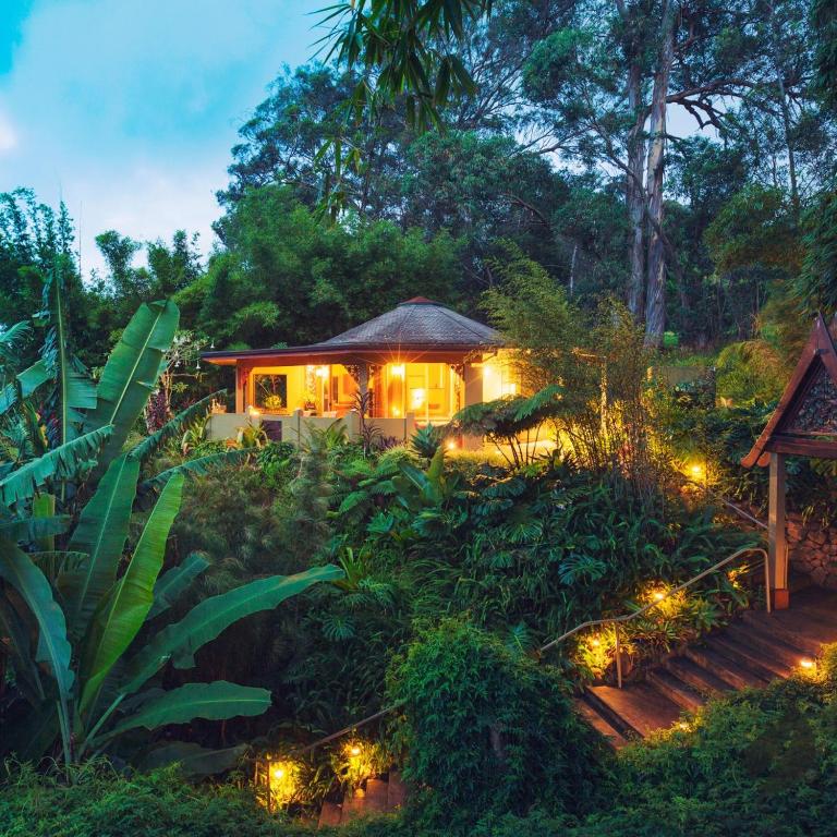 a gazebo with lights in a garden at night at CalmNest Lagos in Ikorodu