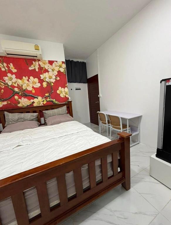 a bedroom with a large bed with a red blanket at Phuket Hostel at Town in Phuket