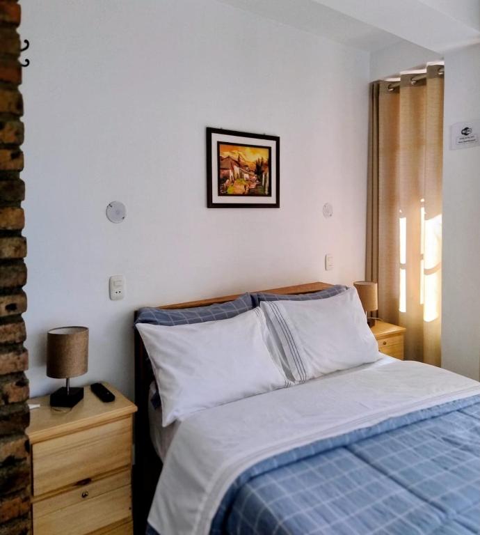 a bedroom with a bed and a picture on the wall at Yoly's House in Caraz