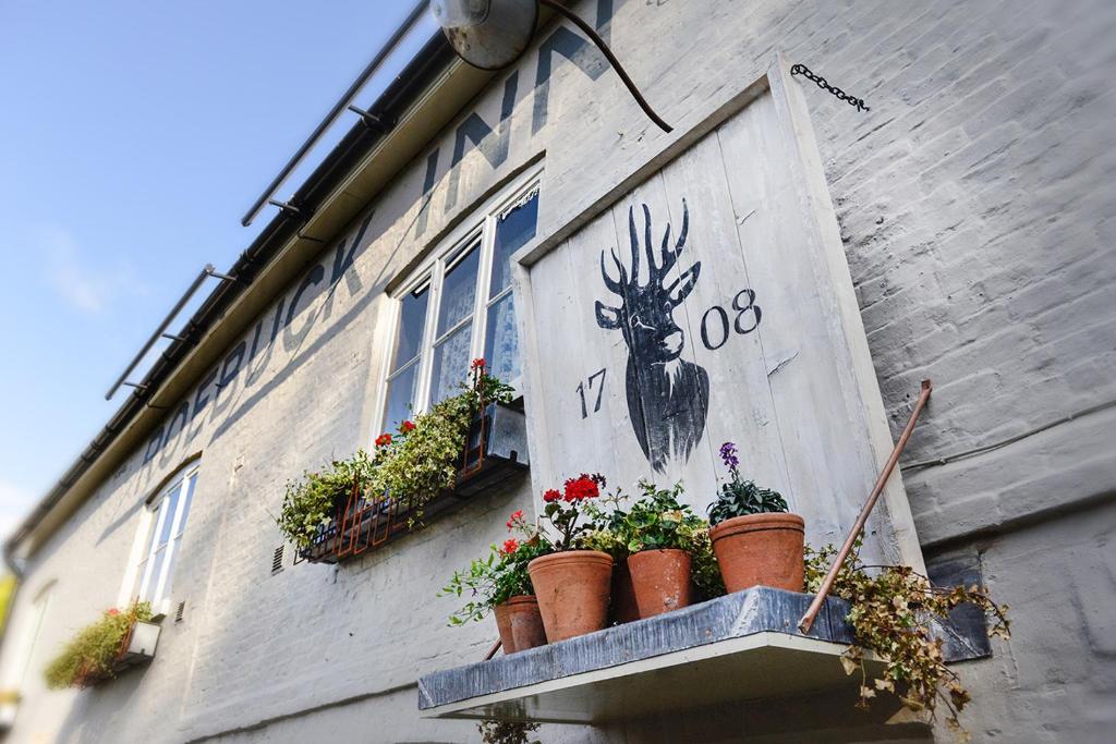 a mural of a deer on the side of a building at The Roebuck Inn in Mobberley
