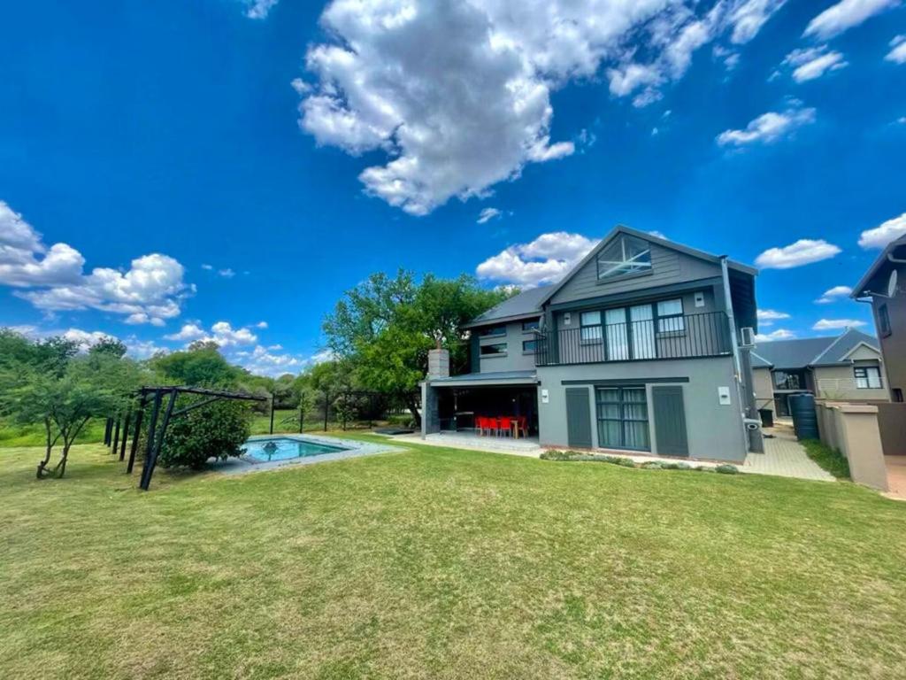 a house with a swimming pool in a yard at Greens & Dreams in Parys