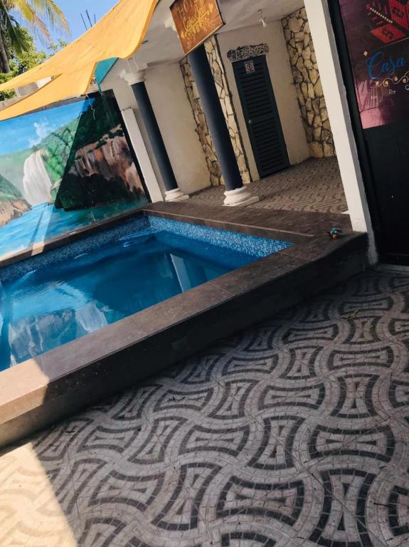 a house with a swimming pool with a tiled floor at Casa Bell in Ciudad Valles