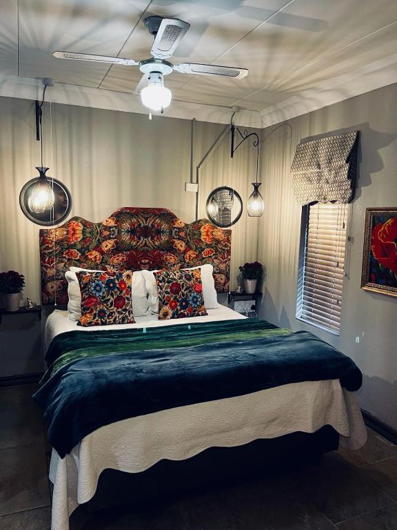 a bedroom with a large bed with a colorful headboard at Highveld Guesthouse in Centurion