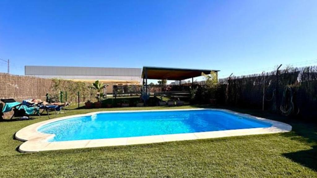 a swimming pool in the middle of a yard at Area Parking Caravane in Seville