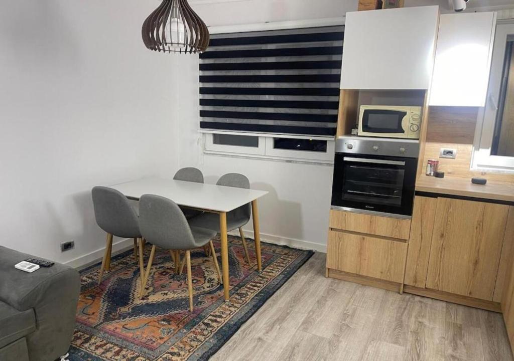a kitchen with a table and chairs in a room at Redi Apartment Center in Elbasan