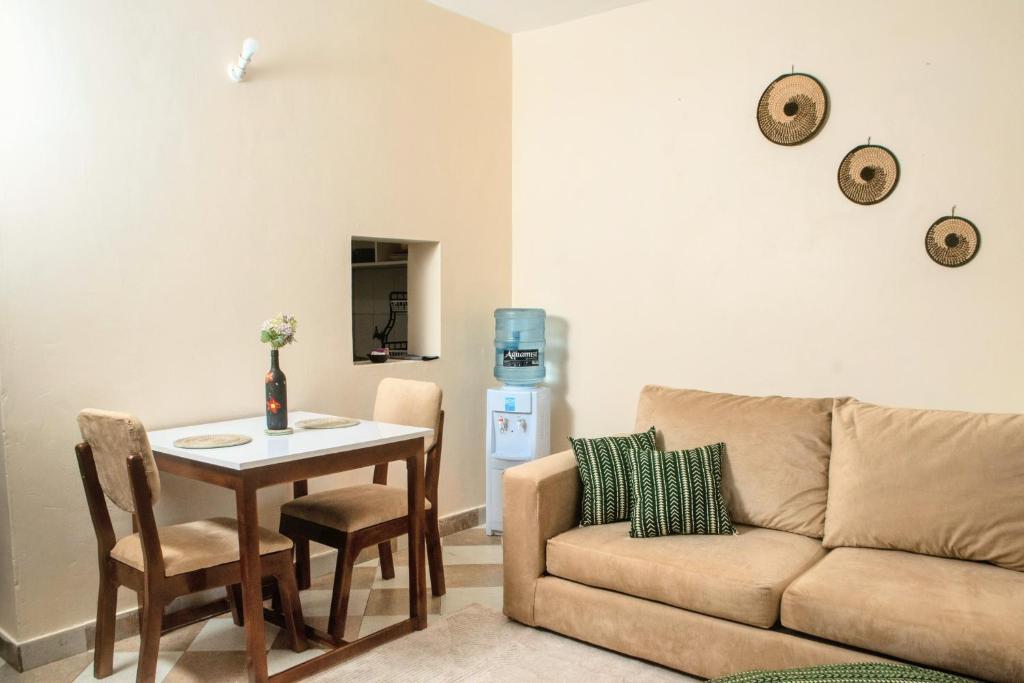 a living room with a couch and a table at Meyer Stays in Kilifi