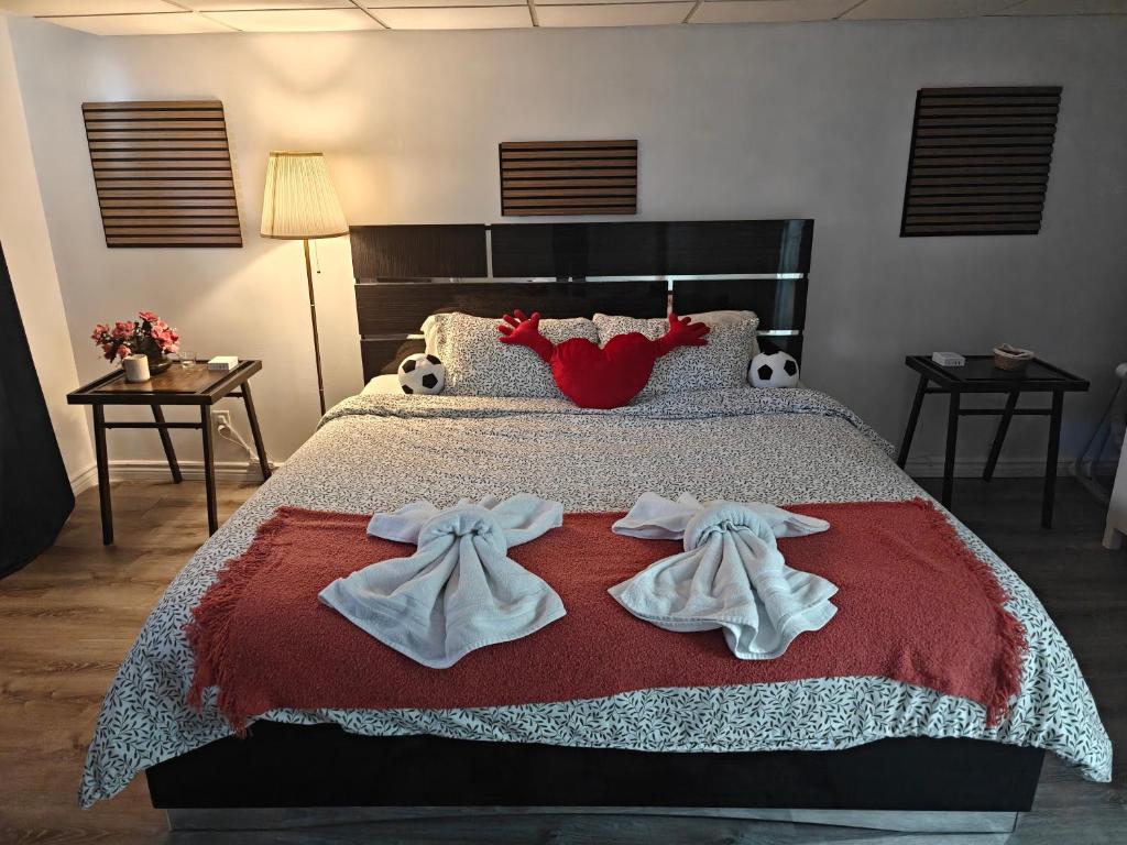 a bedroom with a bed with towels on it at Spacious Basement Lower Suite 3BR Home Stay 1 King 2 Queen Beds 2 Car Parkings FIFA 2026 in Pickering