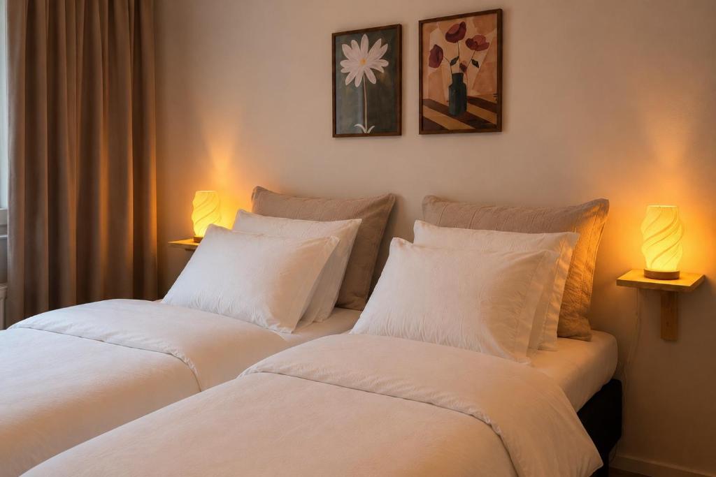 two beds sitting next to each other in a bedroom at Central location with sauna, private yard & parking in Rovaniemi