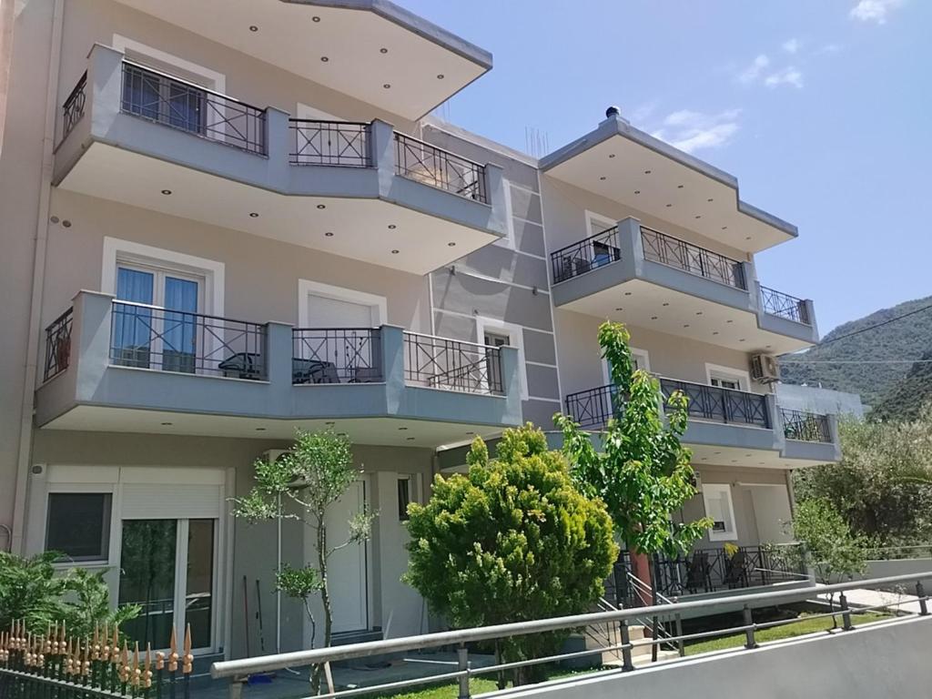 a large apartment building with balconies and trees at Nova Ledeza NL II in Igoumenitsa