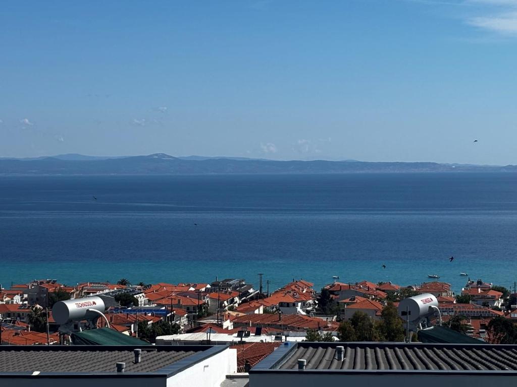 a view of a city with the ocean in the background at Apartment Elias Polychrono in Polychrono