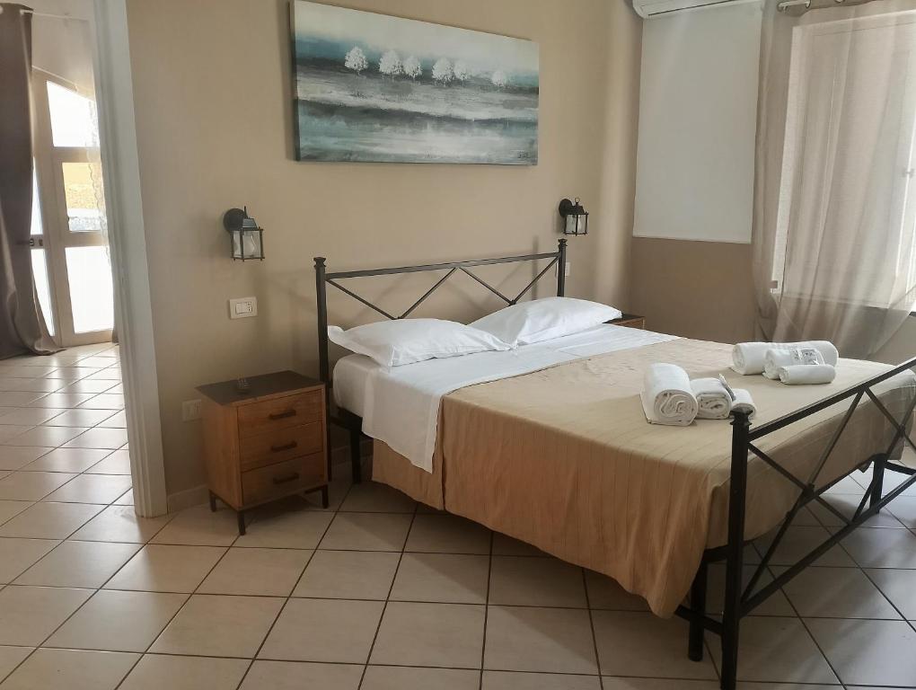 a bedroom with a bed with two towels on it at Dedalo affittacamere in Pompei