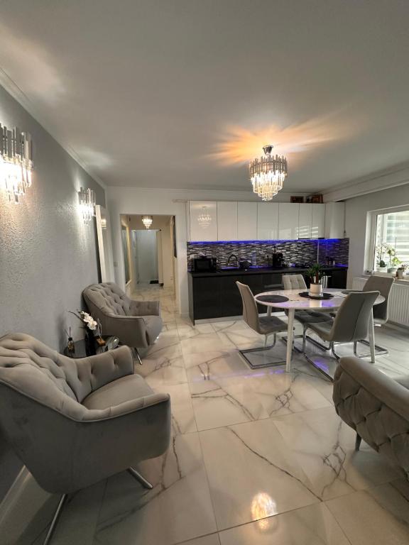 a living room with couches and a dining room at Elite Apartaments in Curtea de Argeş