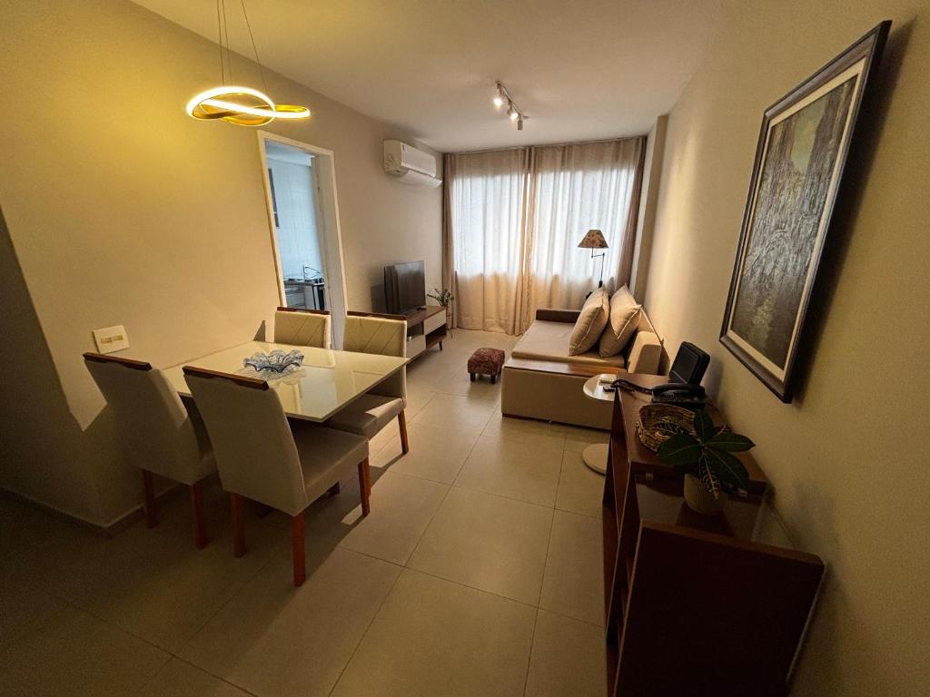 a living room with a table and a dining room at Lar de Noel in Rio de Janeiro