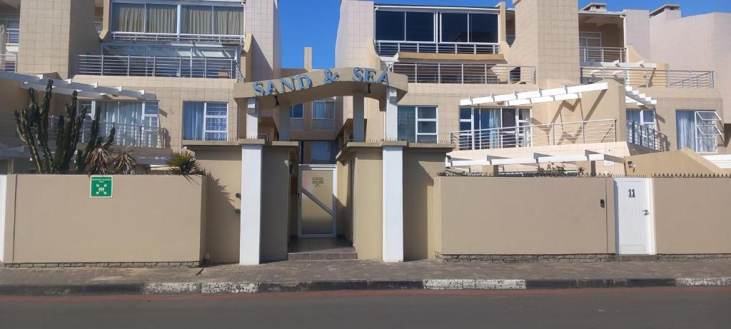 a building with a sign on the side of it at Sand And Sea Self Catering #3 in Swakopmund