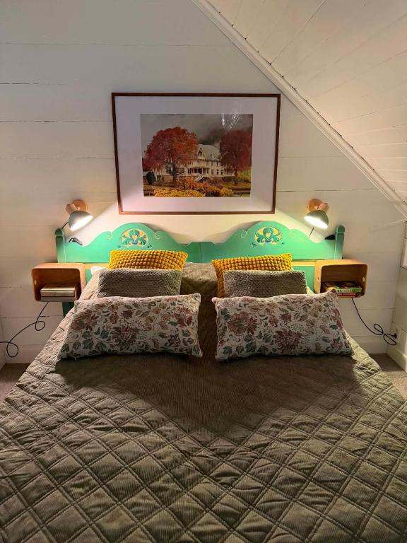 a bedroom with a large bed with a green headboard at Meiriet1936 in Fjarland