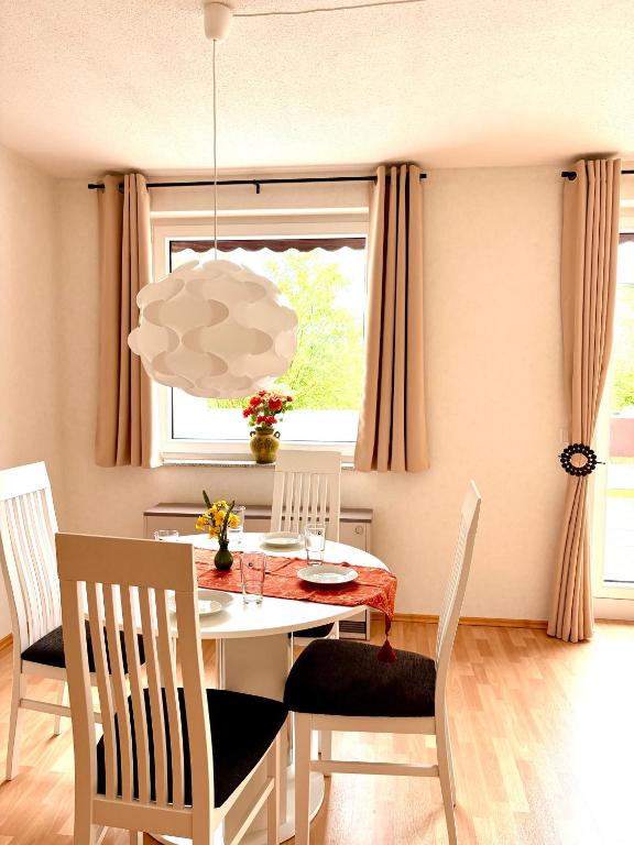 a dining room with a table and chairs and a window at Sorpesee Stay in Sundern