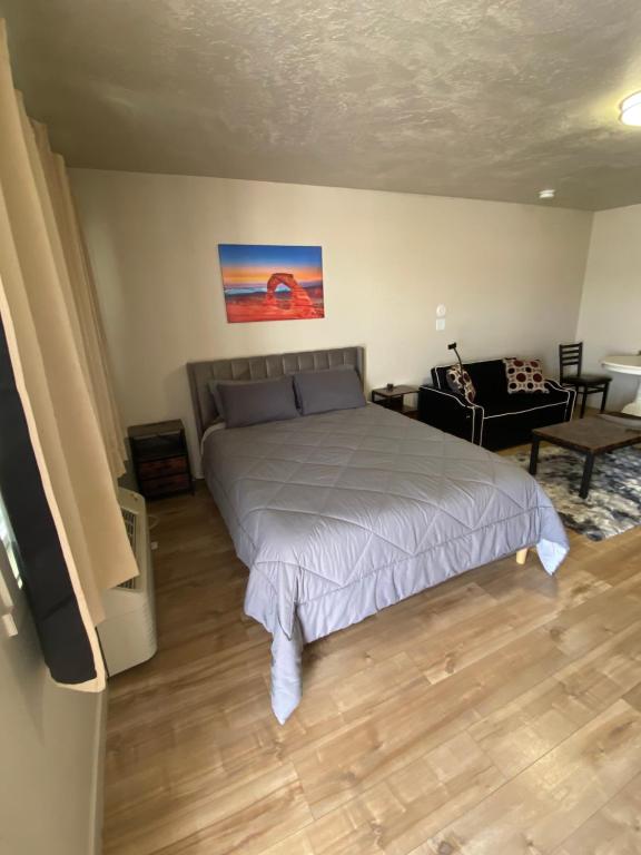a bedroom with a bed and a living room at Green River Inn Apartments in Green River