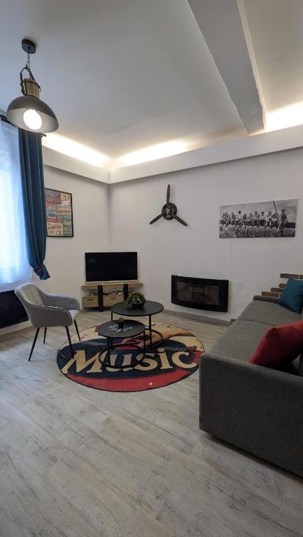 a living room with a couch and a table at L'Atelier du Quai in Mâcon