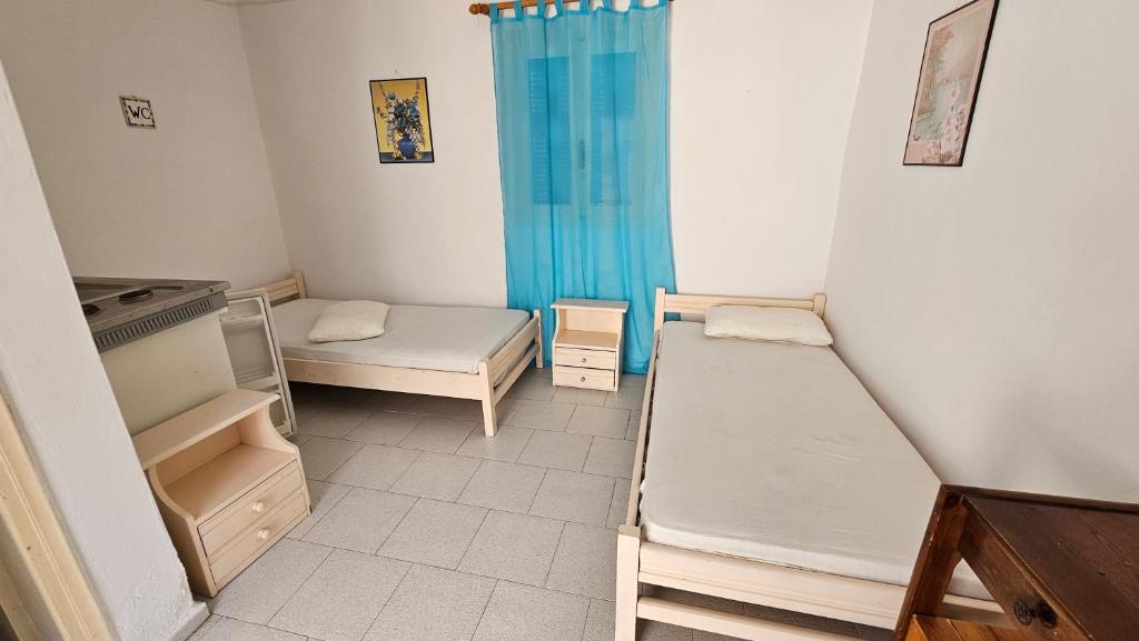 a room with two bunk beds in a room at Small Apartments Rooms Only in Perissa