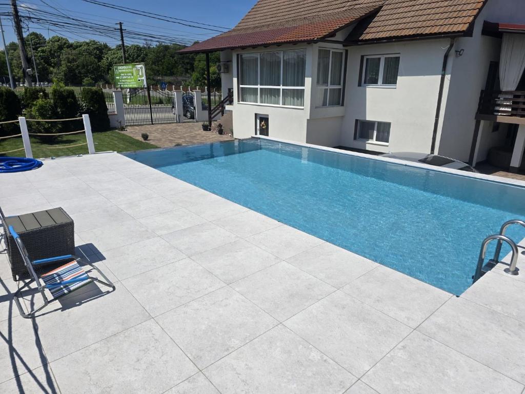 a swimming pool in front of a house at Casa Deac in Sebeş