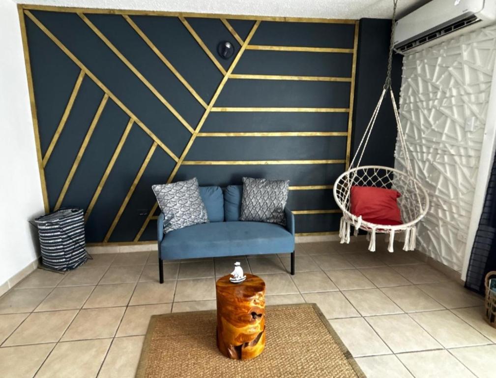 a living room with a blue couch and a chair at Cond. St. Tropez in San Juan