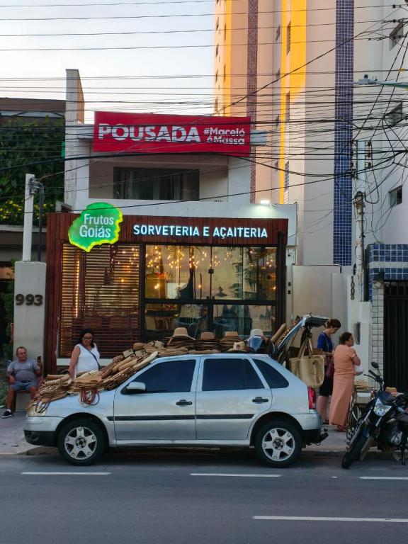 a car parked on the street in front of a store at Pousada Maceió é Massa Beira Mar in Maceió