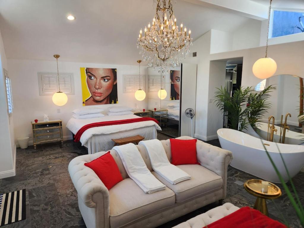 a bedroom with a bed and a bathtub and a bedroom with a bed at Luxury Spa Townhome with Rooftop Ocean View Jacuzzi in Hermosa Beach