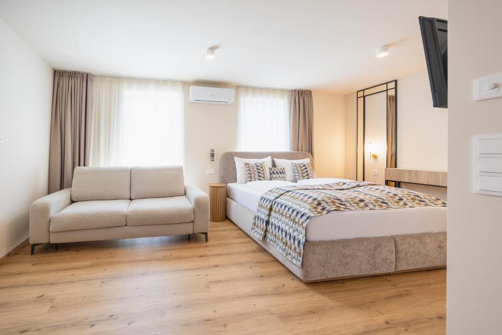 a bedroom with a bed and a chair at Casa Plus in Villach