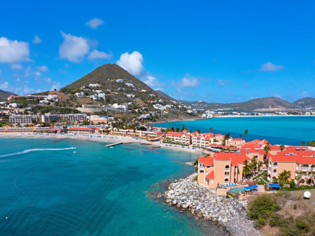 an aerial view of a beach with houses and the ocean at Oceans at Divi Little Bay in Philipsburg