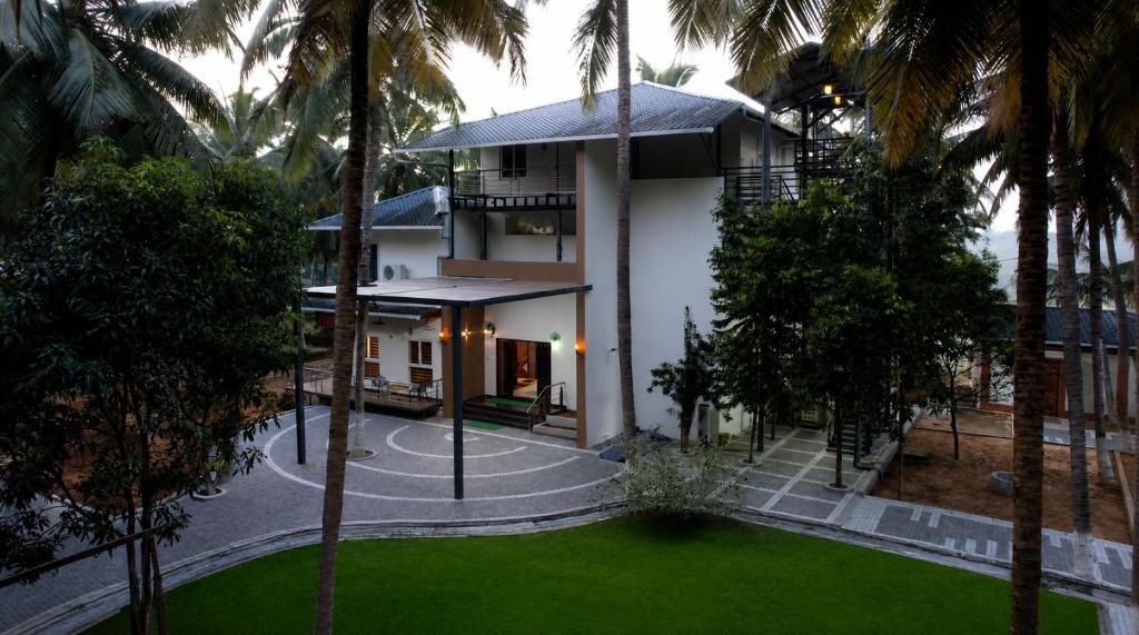 an aerial view of a house with palm trees at Winners Hill Resort Walayar by Arcadia in Coimbatore