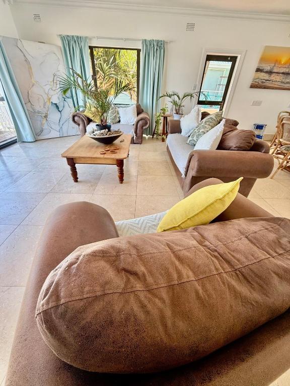 a large living room with couches and a table at Skye Beach Villa in Tergniet