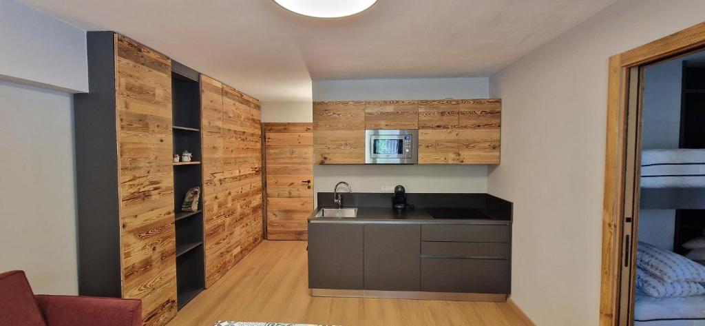 a kitchen with wooden walls and a sink in a room at Valtour House in Valtournenche