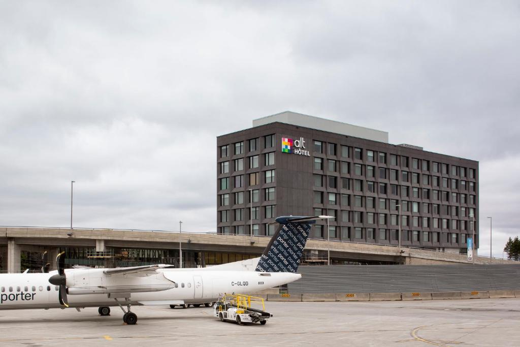 a plane is parked in front of a hotel at Alt Hotel Ottawa Airport in Ottawa