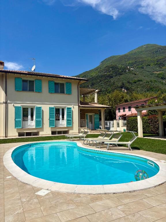 a swimming pool in front of a house at Villa Lena in Camaiore