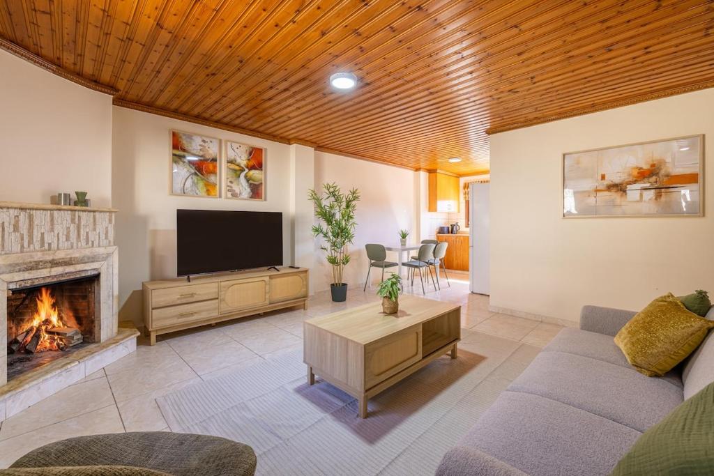 a living room with a couch and a fireplace at All Saints Retreat in Koilani