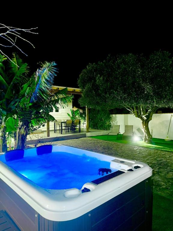 a hot tub in a yard at night at Casa Ana & Spa in Conil de la Frontera