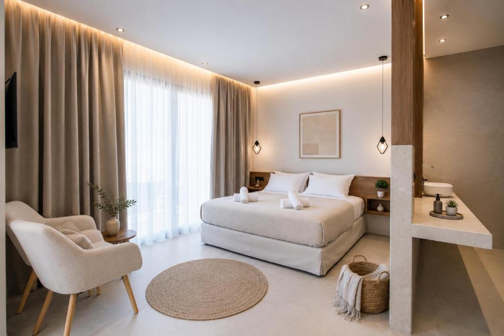 a hotel room with a bed and a chair at Kastri Beach Suites in Faliraki