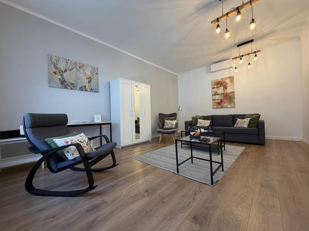 a living room with a couch and a table at Zwinger Apartman in Sopron