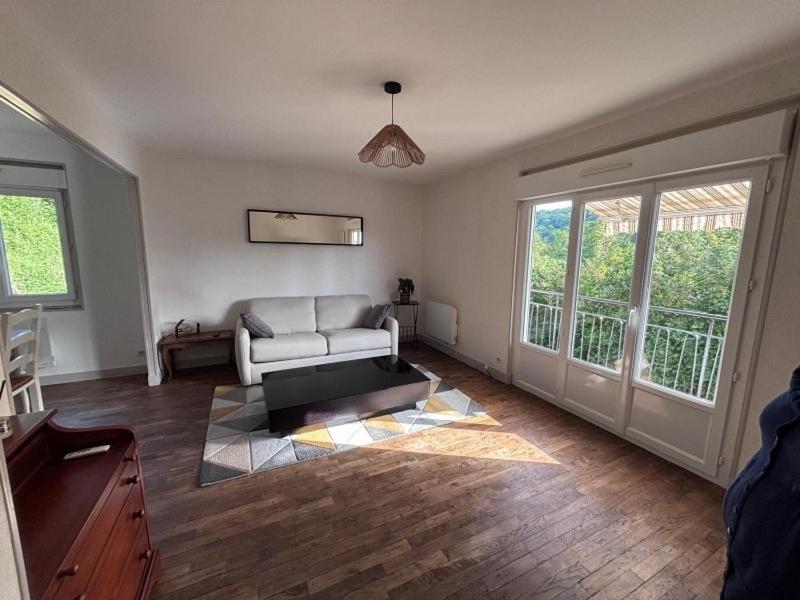 a living room with a couch and a window at la maisonnette in Nogent-le-Rotrou