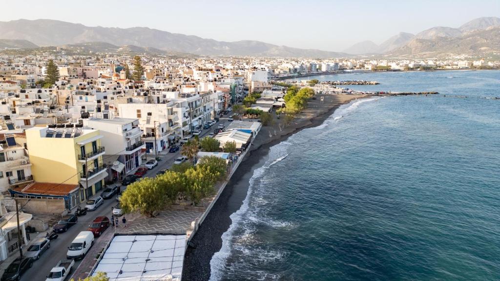 an aerial view of a city and the ocean at By Captains Studio in Ierapetra