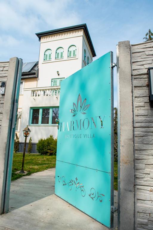 a sign for the entrance to the hampton syracuse university building at Harmony Boutique Villa in Siófok