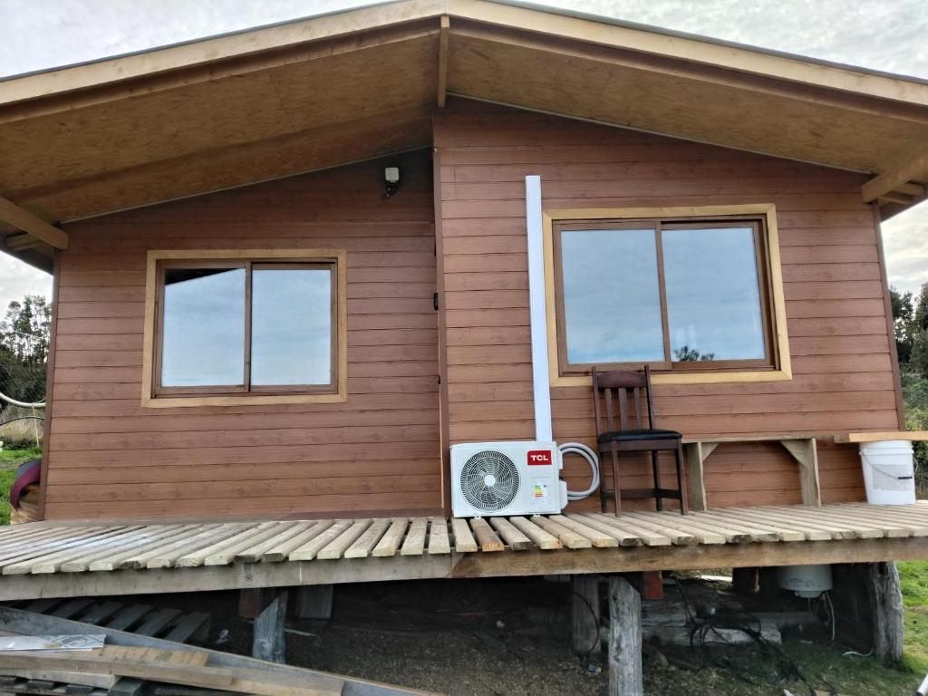 a tiny house with a porch and a speaker at Cabañas almendra in Quellón