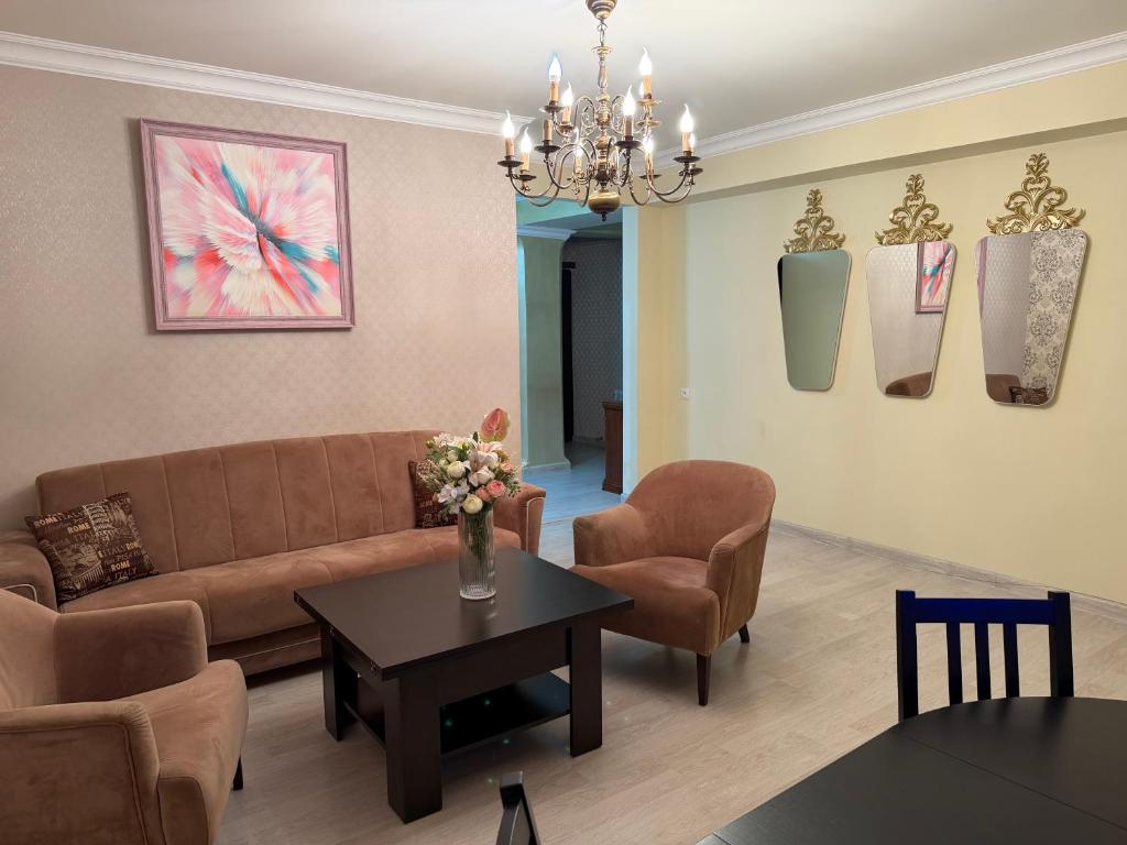a living room with a couch and chairs and a table at Erebuni in Yerevan