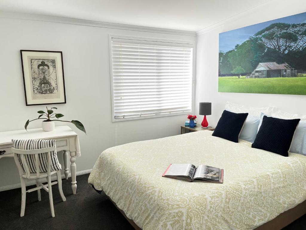 a bedroom with a bed with a desk and a book on it at Nicole Guest House - Private Room & Bathroom - 6kms from City in Brisbane