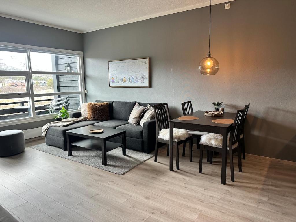a living room with a couch and a table at Modern apartment with amazing location in Hol