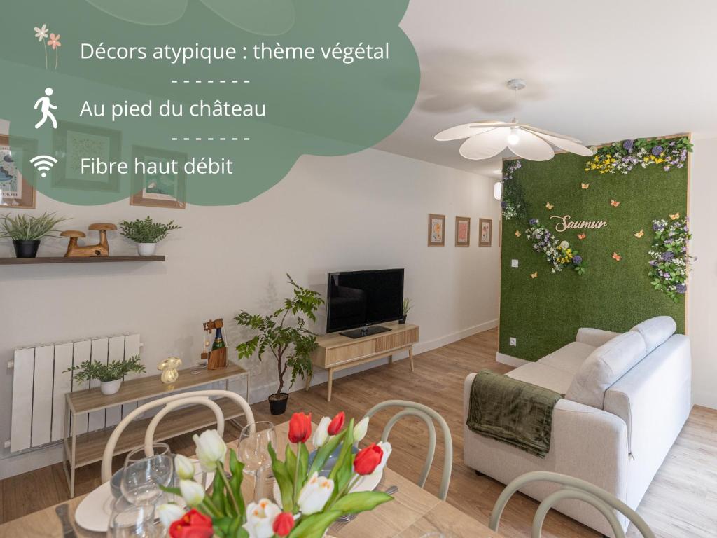 a living room with a couch and a tv at L'Escapade Végétale - Centre Ville in Saumur